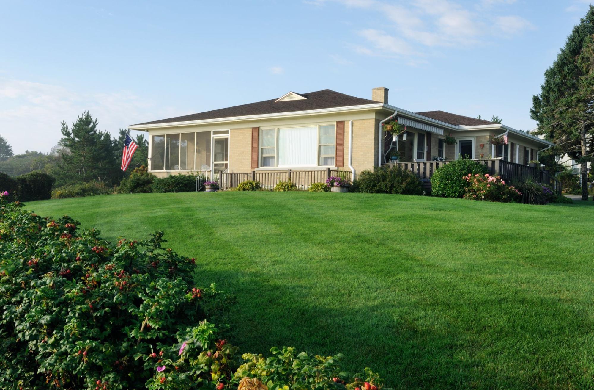 Graded yard sloped away from a house for proper surface drainage.