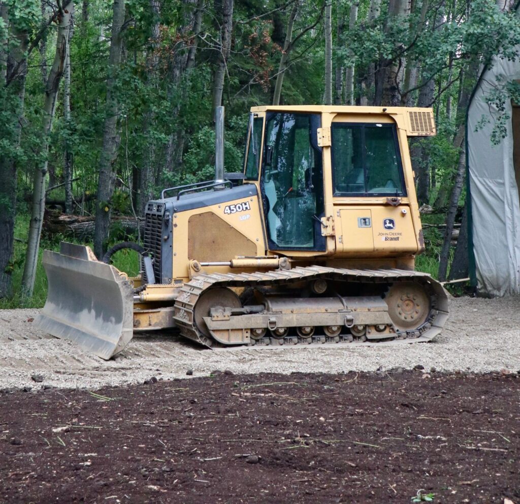 A crawler dozer finishing a level gravel pad, the kind of lot grading work A4 Excavation handles in Boise.